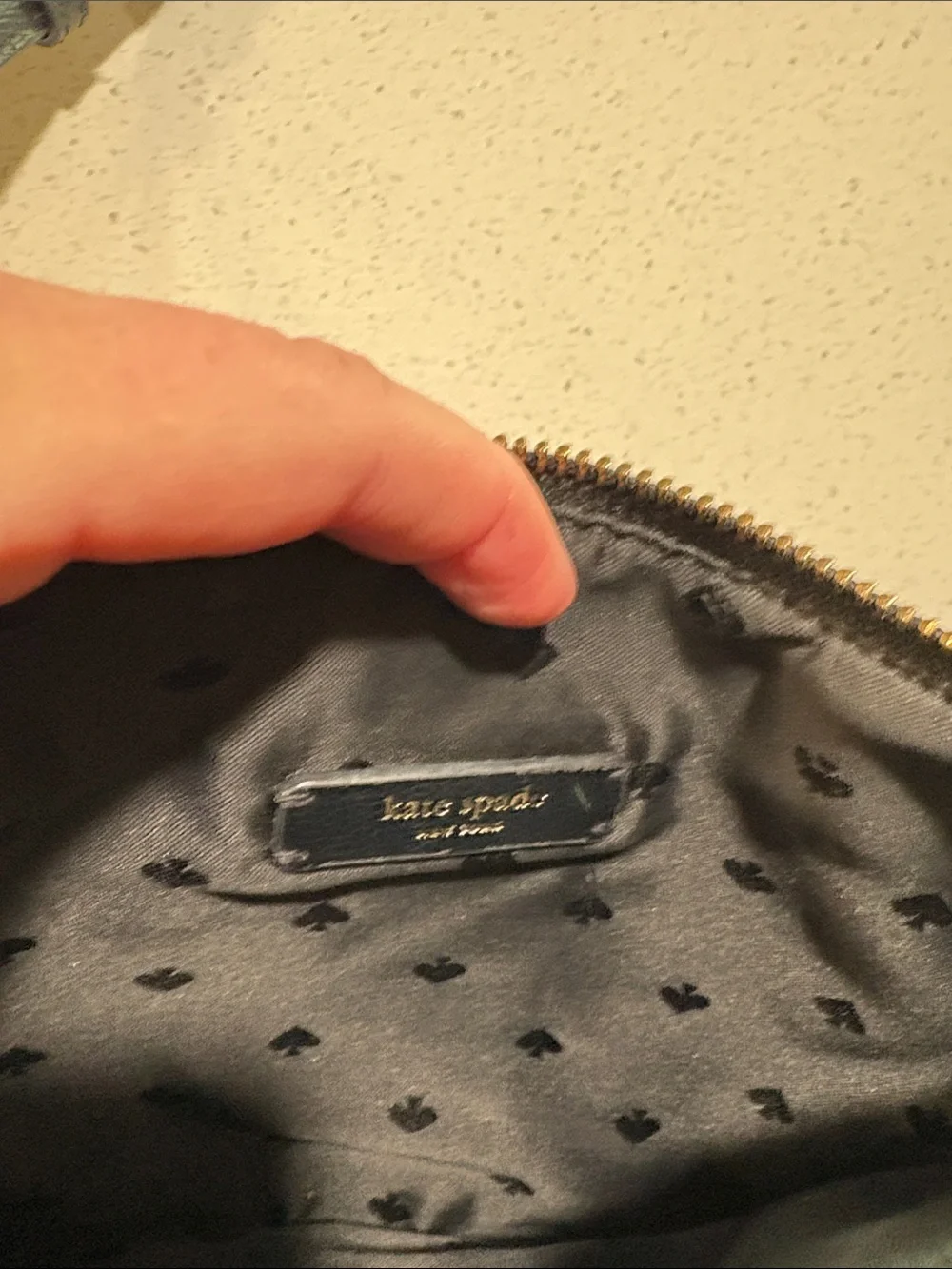 kate spade black crossbody pouch with gold-tone logo